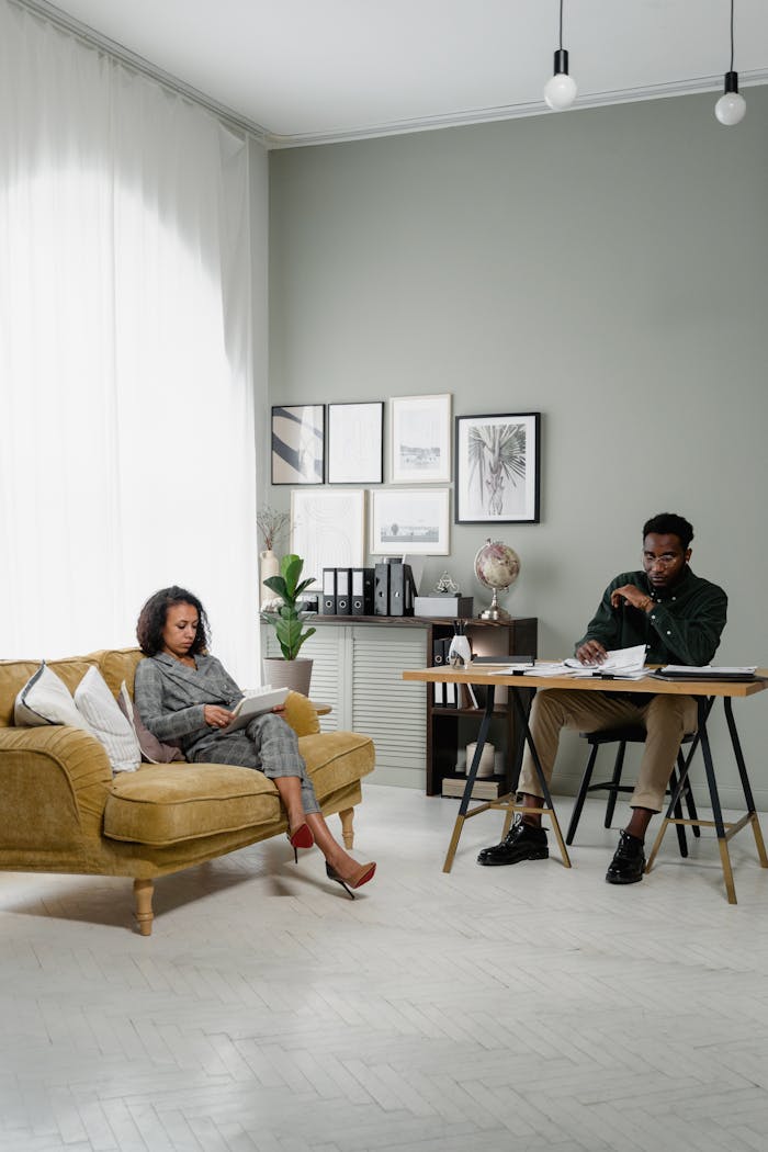 about-us Elegant modern office space with a man and woman working together indoors, emphasizing finance and collaboration.