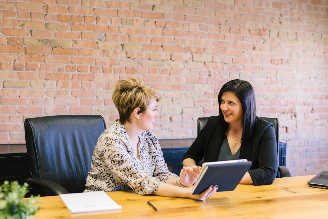 services-03 two-women-sitting-on-leather-chairs-in-front-of-table-k0c8ko3e6aa